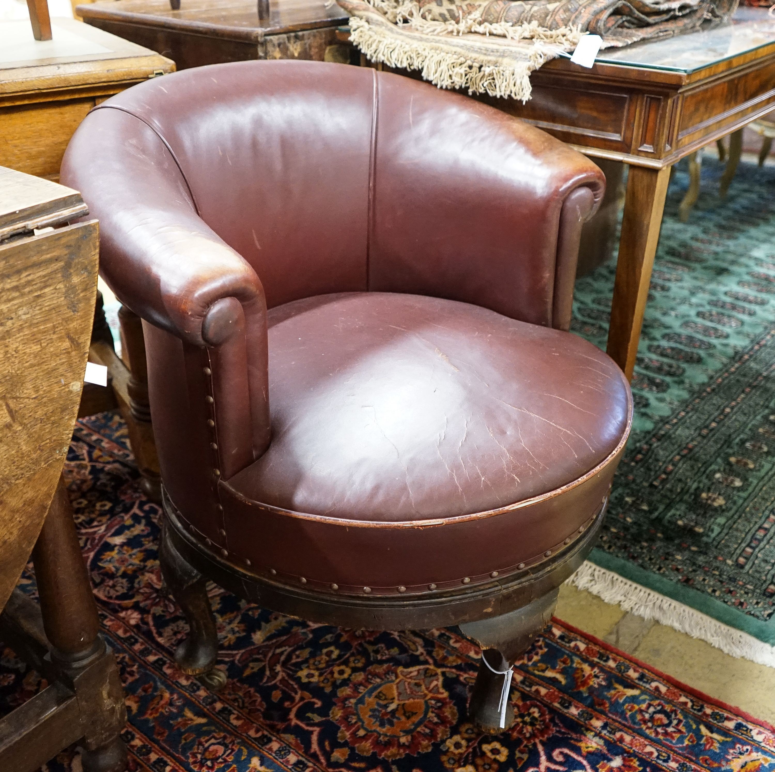 A late Victorian mahogany burgundy leather tub frame swivel desk chair, width 72cm, depth 62cm, height 74cm